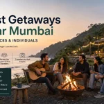 A group of office colleagues at a scenic resort near Mumbai with the Western Ghats in the background, on a corporate team outing from the city.