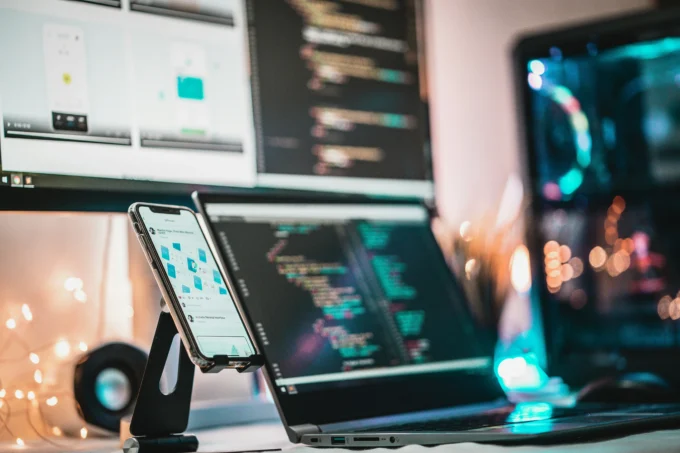 Laptop and smartphone displaying data analytics dashboards and code, representing the journey to becoming a Data Analyst in India.