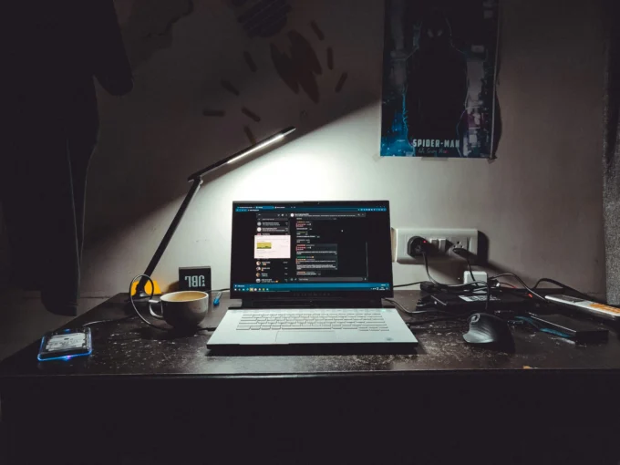 Software engineering workspace with a laptop, coding environment, desk lamp, and coffee mug, representing the path to becoming a Software Engineer in India.