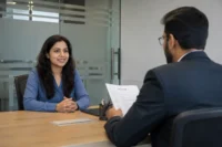 Job candidate attending a professional interview with a hiring manager in a modern office, representing interview preparation, recruitment, hiring, and career opportunities.
