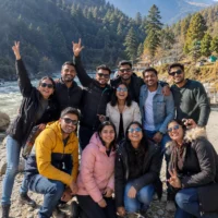 Group of professionals enjoying a team outing getaway in a scenic mountain destination, representing corporate team building, employee engagement, workplace culture, and company retreats.